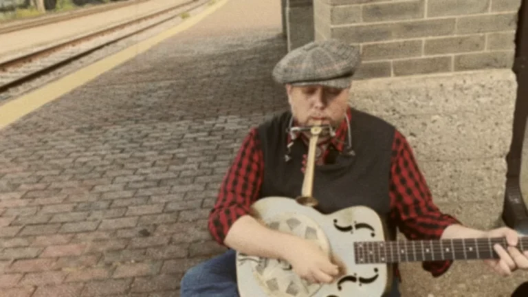 Street singer Jack Norton playing steel guitar and singing "Hot Time In The Old Town Tonight"