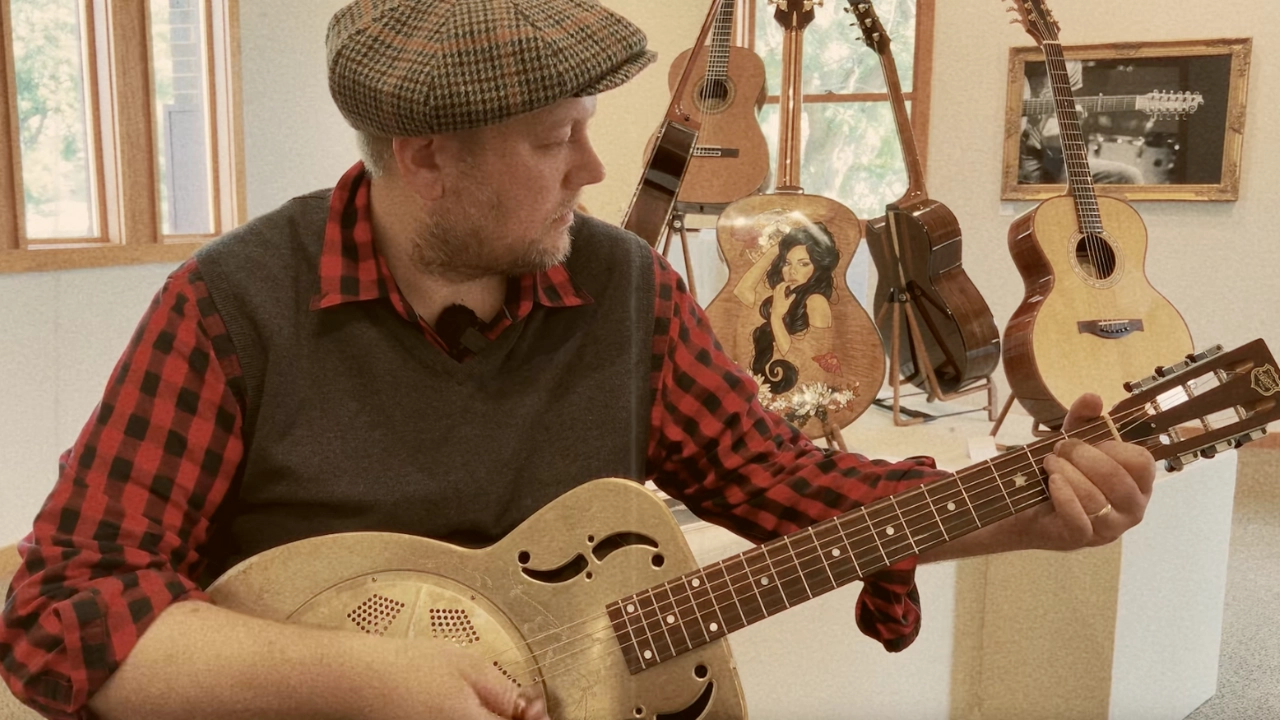 Jack Norton playing resonator guitar at train depot in Red Wing, Minnesota
