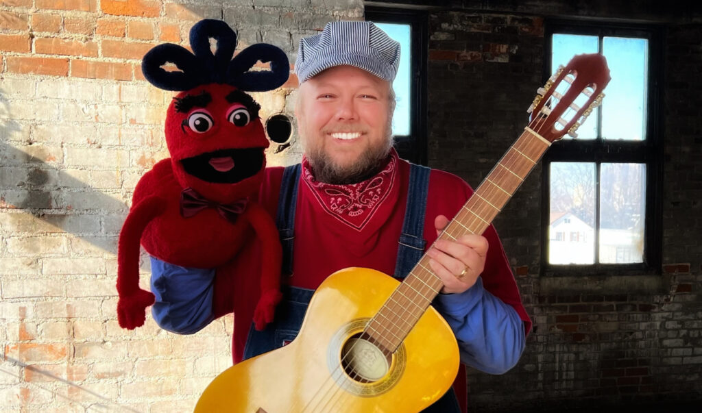 Jack Norton as children's musician "Conductor Jack" - with guitar and hand puppet